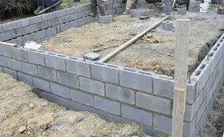 Professionals building a foundation with blocks in Tuscaloosa, AL