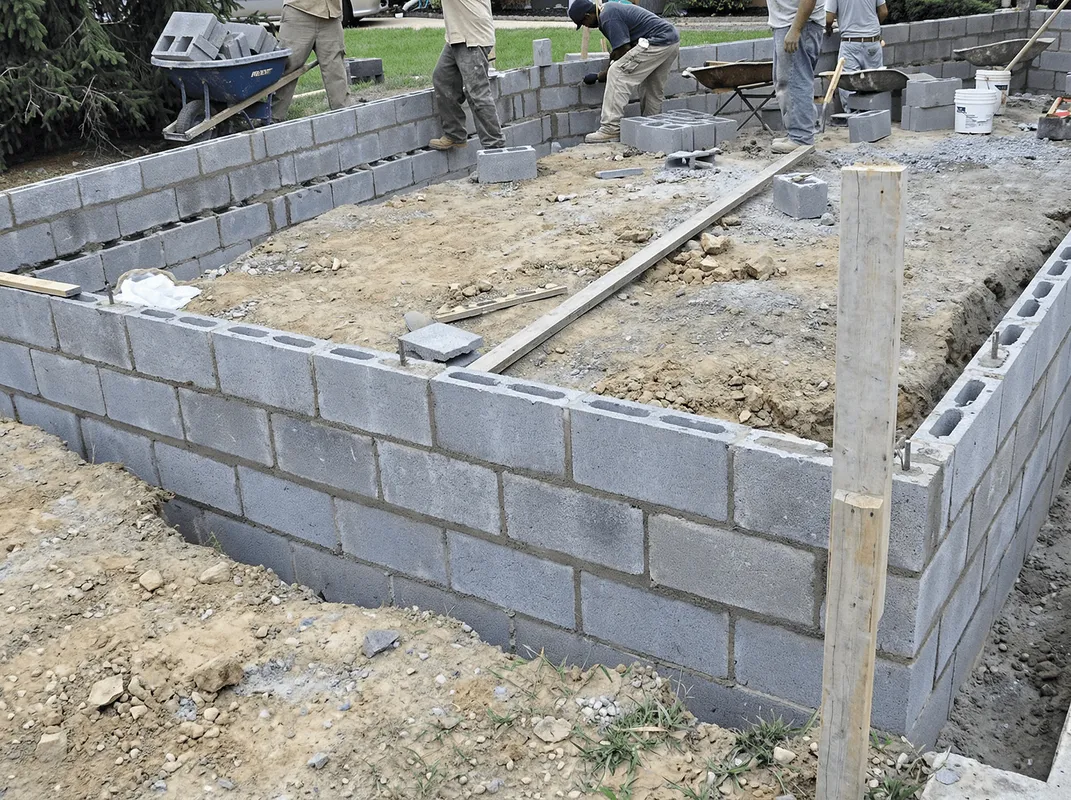 Professionals building a foundation with blocks in Tuscaloosa, AL